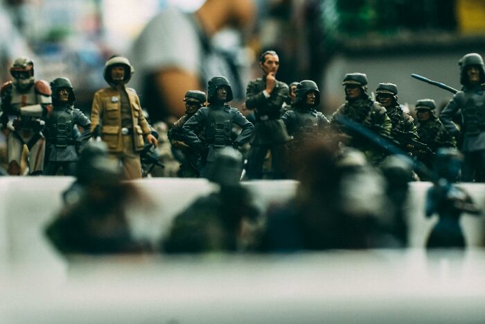 Close-up of miniature military figures arranged in a row representing soldiers, related to Morse code brain teasers.