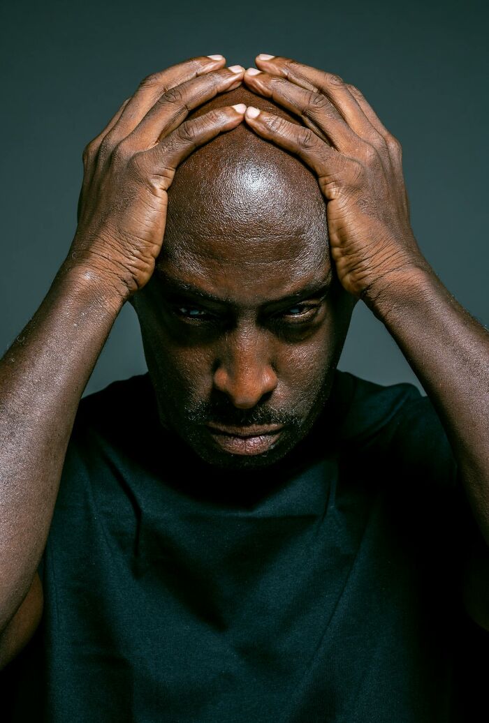 Man with hands on head looking stressed, reflecting on things that shocked people after they got out of prison