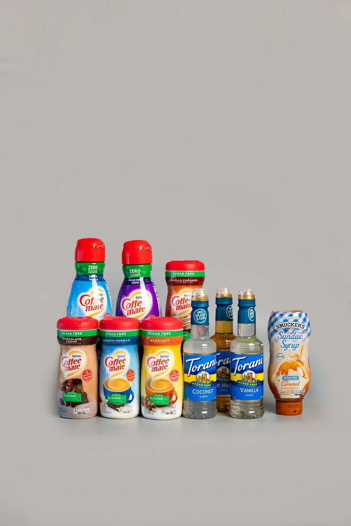 Various sugar-free coffee creamers and syrups displayed on a plain background, highlighting items that shocked people after prison.