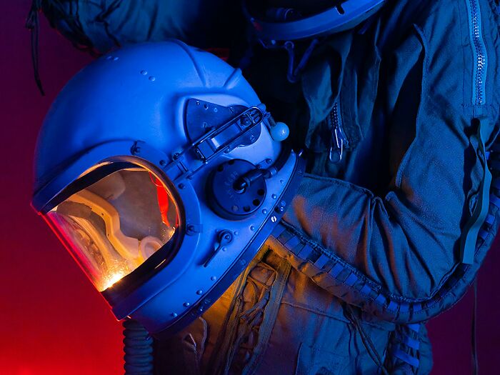 Astronaut suit and helmet illuminated in blue and red light showcasing lesser-known facts about these countries.