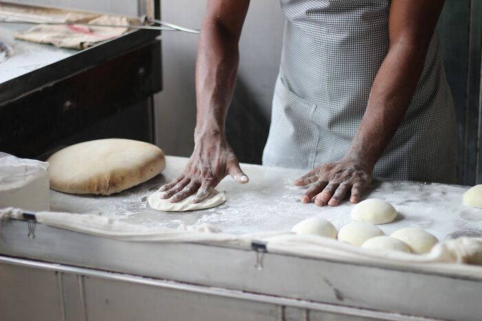 Worker preparing dough during a night shift, capturing the 3 AM chaos stories of demanding night shift work.