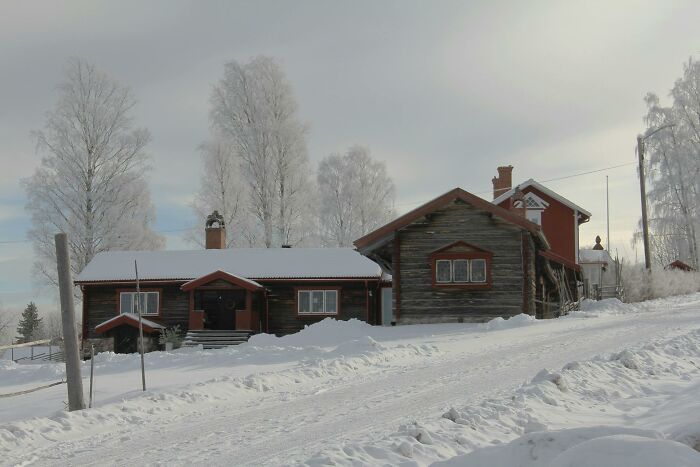 Snow-covered wooden houses in a rural setting with frosted trees highlighting lesser-known facts about these countries.
