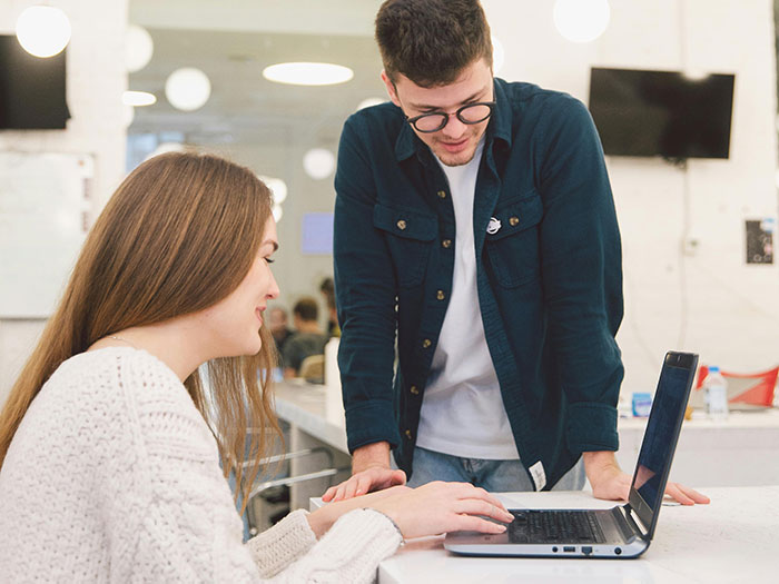 Woman puts coworker on blast on social media, shocked reaction in office setting with laptop and casual attire Woman puts coworker on blast on social media, shocked reaction in office setting with laptop and casual attire