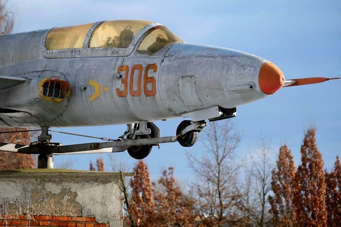 Vintage military jet with number 306 displayed, illustrating lesser-known facts about these countries in an outdoor setting.