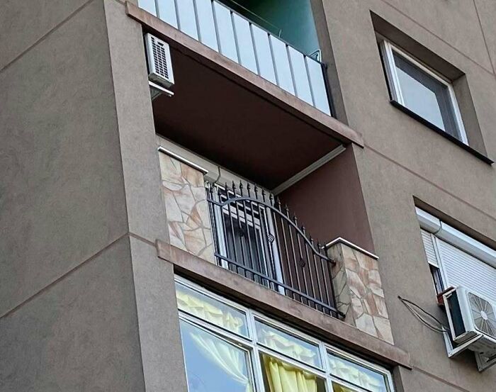 Balcony with metal gate on an apartment building, illustrating funny Eastern European experience and living space humor.