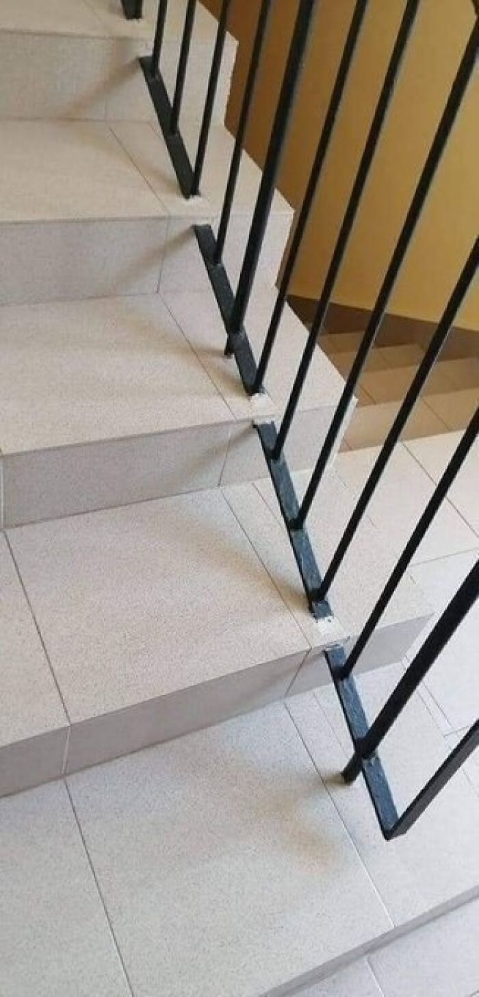 Staircase with railing installed incorrectly, showing a humorous Eastern European experience in construction and design.