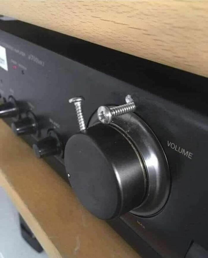 Volume k**b repaired with screws on audio equipment, illustrating a funny Eastern European experience workaround.