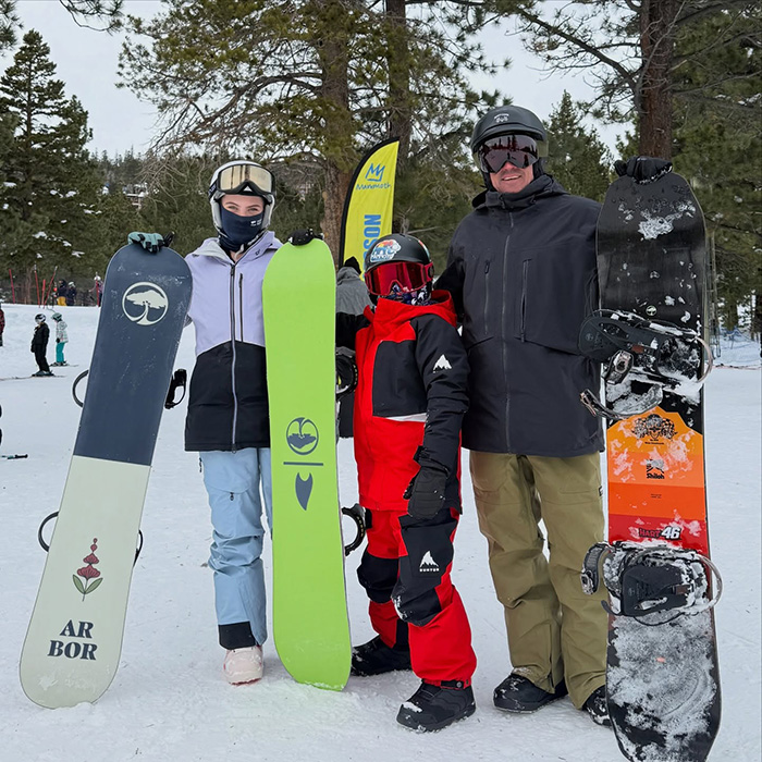 Three people holding snowboards outdoors in winter, related to Pink breaks silence after spending New Year&rsquo;s Eve alone in hospital.