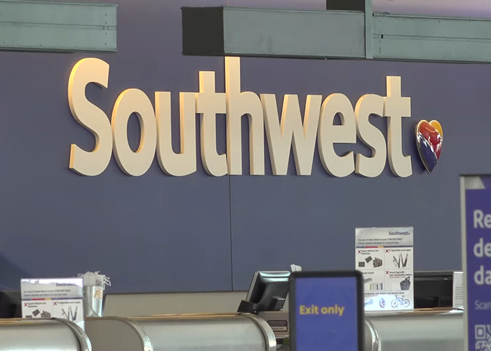 Southwest Airlines check-in counter with signage amid backlash over new plus size passenger seating rules.