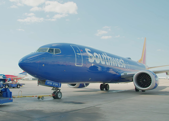 Southwest Airlines airplane parked on runway amid backlash over new seating rules for plus size passengers.