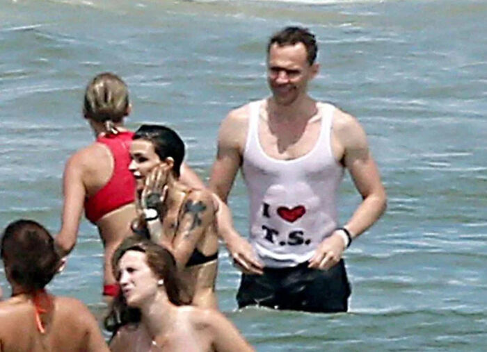 A group of people in swimwear standing in the water, capturing a pop culture moment that made people cringe hard.