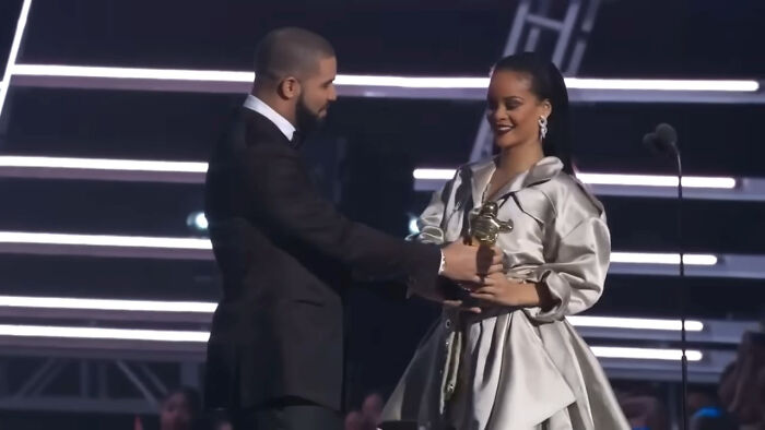 Drake handing an award to Rihanna on stage during a pop culture moment that made people cringe hard.