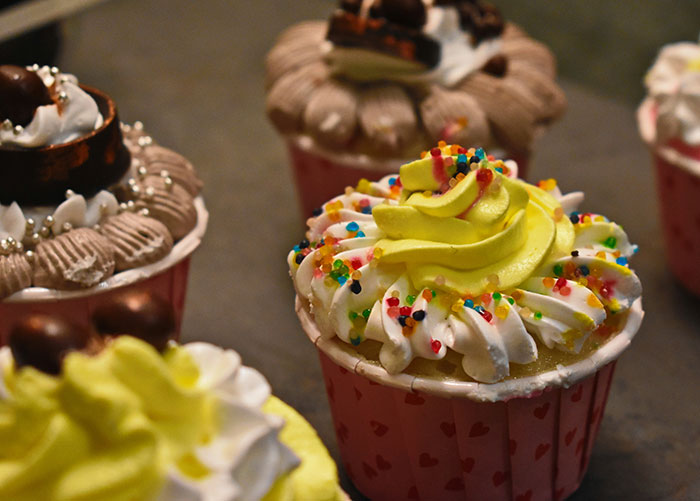 Cupcakes with colorful frosting and sprinkles, representing insights from professionals about their jobs unknown to the public.