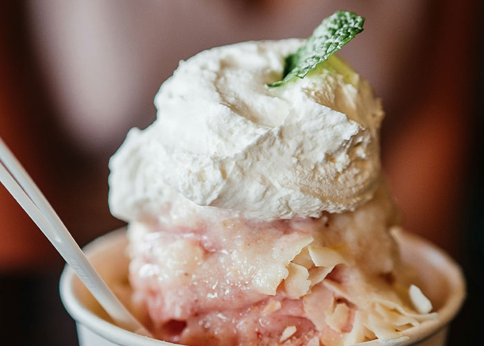 Close-up of a dessert with whipped cream and mint, illustrating insights shared by professionals about their jobs.