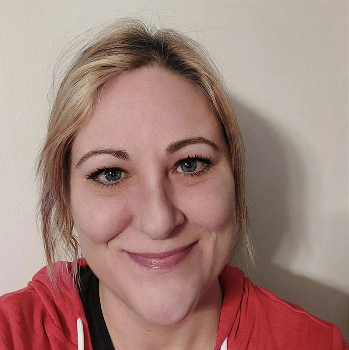 Smiling woman with blonde hair in a red hoodie, representing lawyer aged 44 mentioned in the transatlantic flight news.