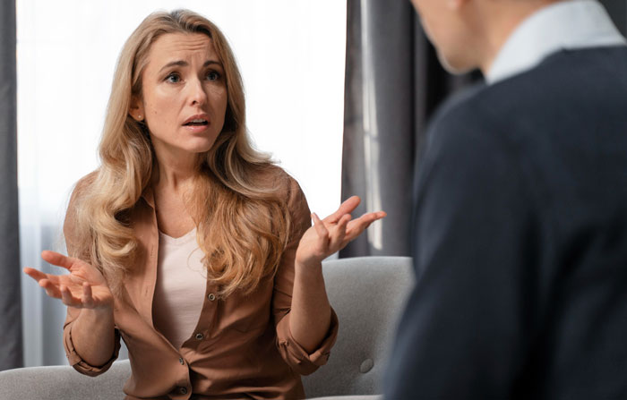 Concerned mother speaking with principal about autistic kid humiliated at school and excluded from class trip.