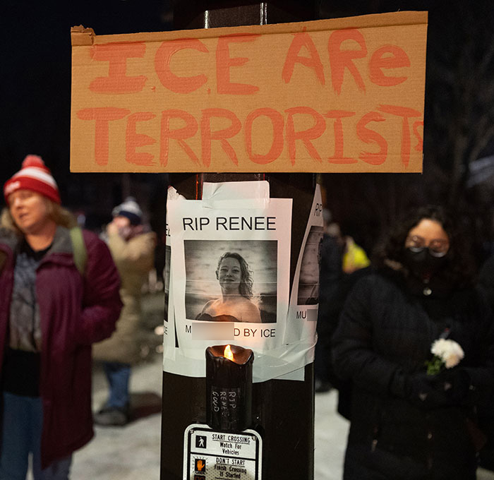 Protesters gather near vigil with signs condemning ICE after mom of a 6-year-old k****d in Minneapolis car incident.