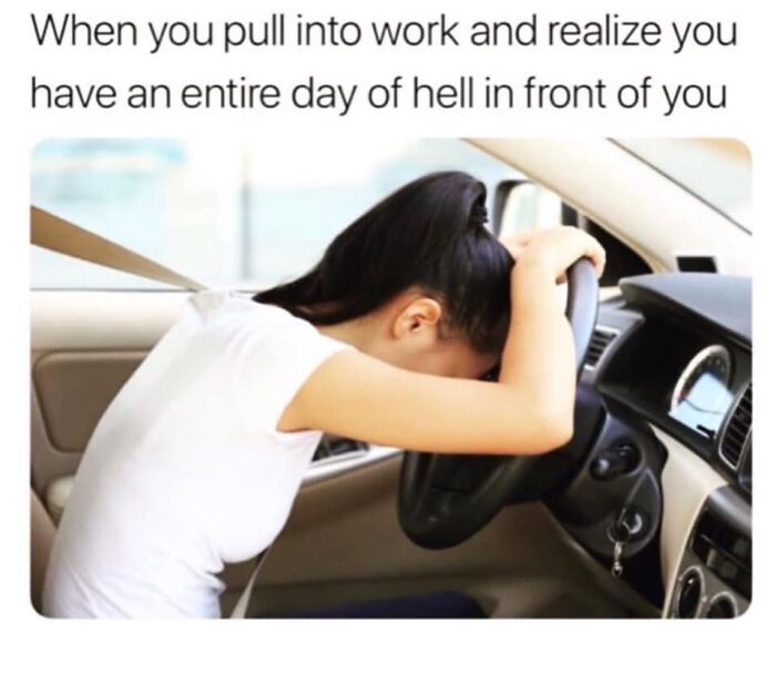 Stressed restaurant worker sitting in a car, holding head on steering wheel, facing a long challenging workday.