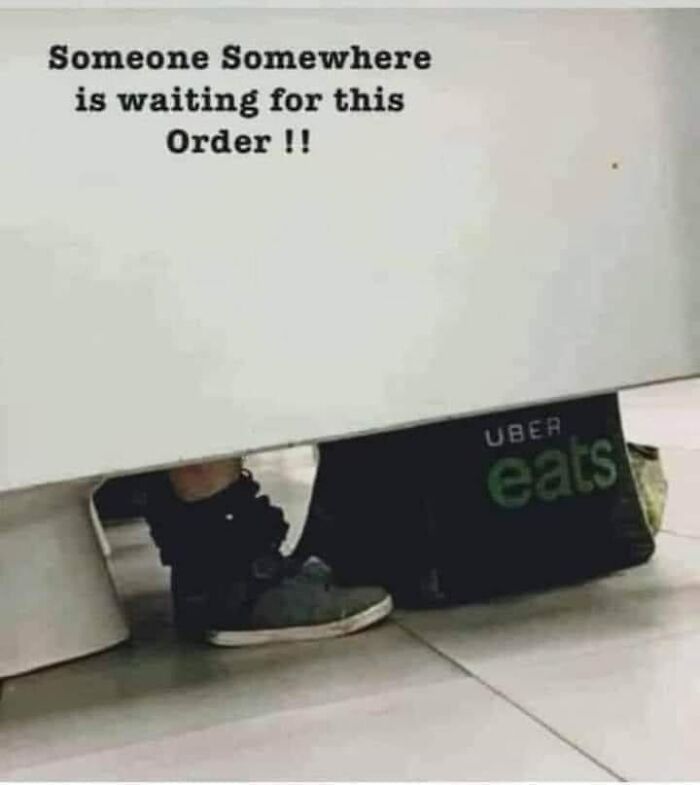 Person hiding behind a wall with Uber Eats delivery bag and text about restaurant workers relating to orders waiting patiently.