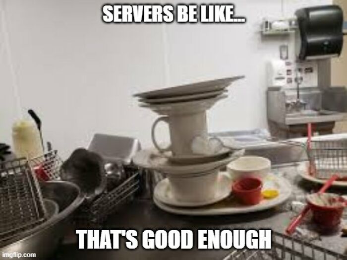 Stacked dirty dishes and cups in a busy kitchen, illustrating relatable moments for restaurant workers and servers.