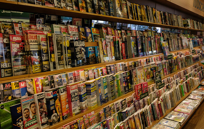 Magazine rack filled with various titles illustrating stories of people getting the last laugh through glorious revenge moments.