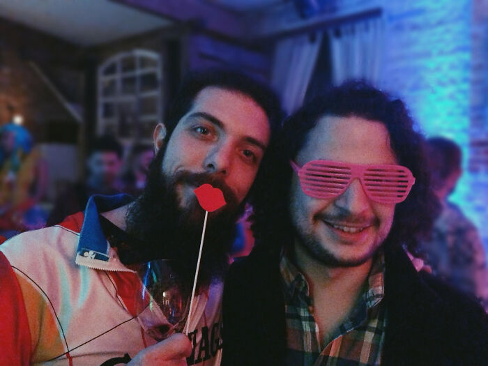 Two men at a party having fun, symbolizing people meeting their high school bully as adults and karma moments.