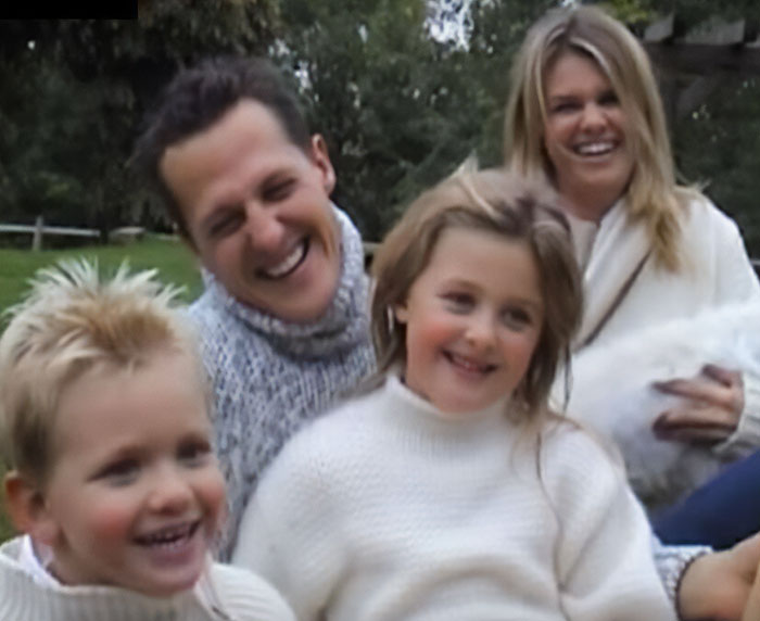 Michael Schumacher with family outdoors, sharing a joyful moment amidst a major health update after his F1 accident.
