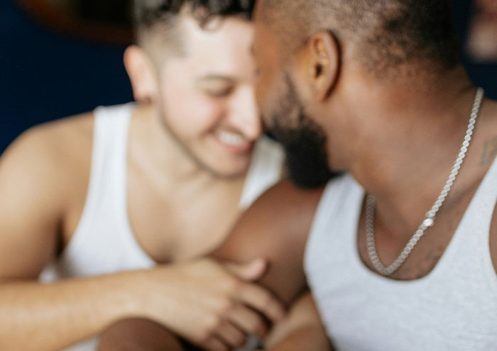 Two men sharing a close moment, symbolizing anonymous people revealing explosive secrets confidentially.