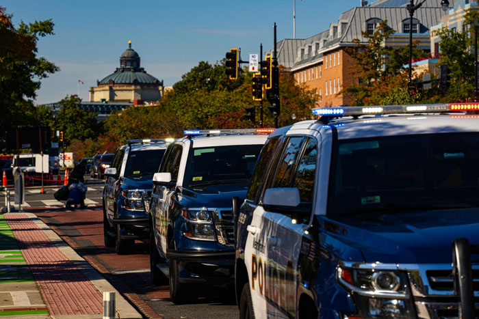 Line of police SUVs with flashing lights parked on a city street related to CPS involvement and family neglect issues. Line of police SUVs with flashing lights parked on a city street related to CPS involvement and family neglect issues.
