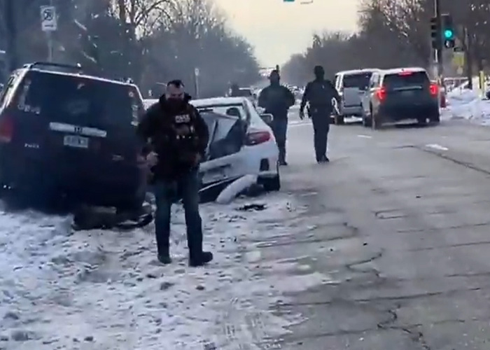 ICE agent at snowy crash scene with damaged vehicles on a city street, related to Stephen King backlash post.