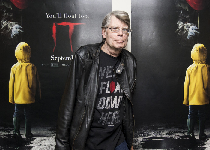 Stephen King wearing a leather jacket at an event, facing backlash over post about ICE agent Jonathan Ross.