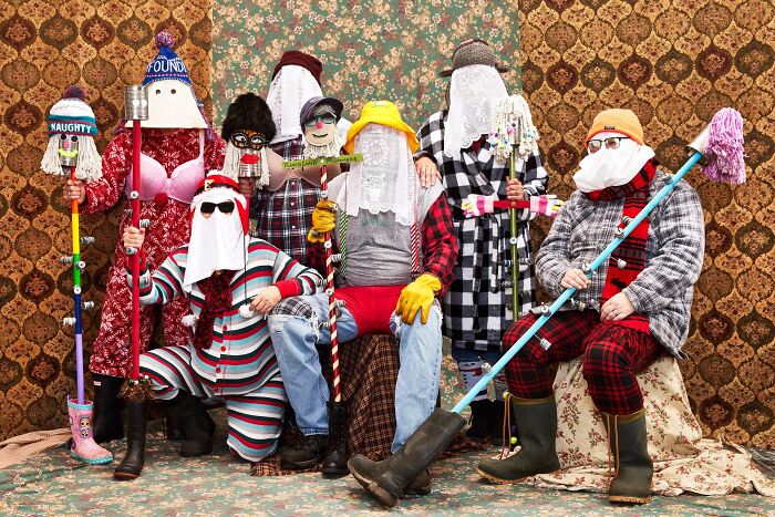 Group of people in quirky costumes and masks, representing strange and unusual traditions from around the world.