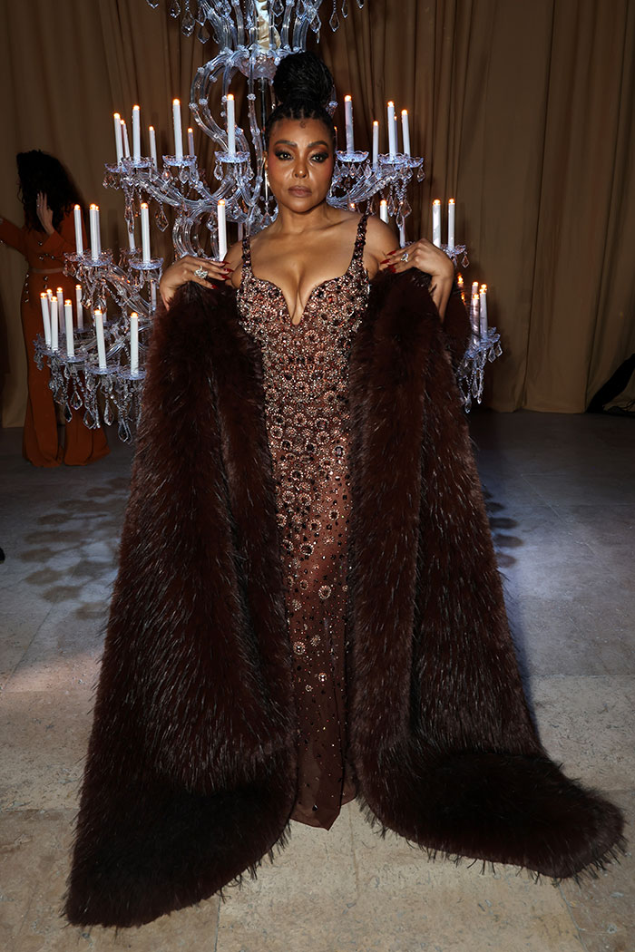 Taraji P. Henson in a jeweled gown and fur coat at an event, with fans noting changes in her face appearance.
