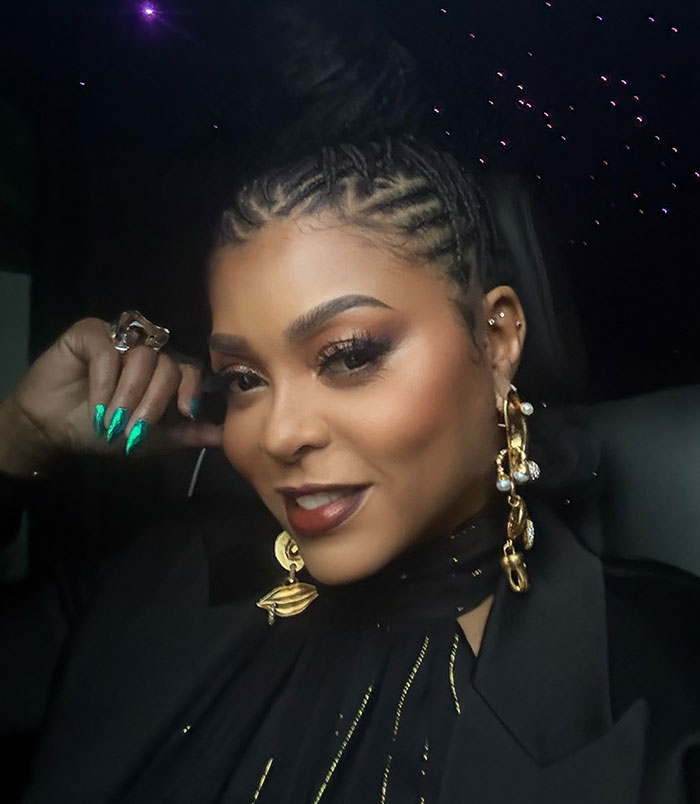 Taraji P. Henson posing with braided hair, bold makeup, gold earrings, and green nails, sparking face changes discussion.