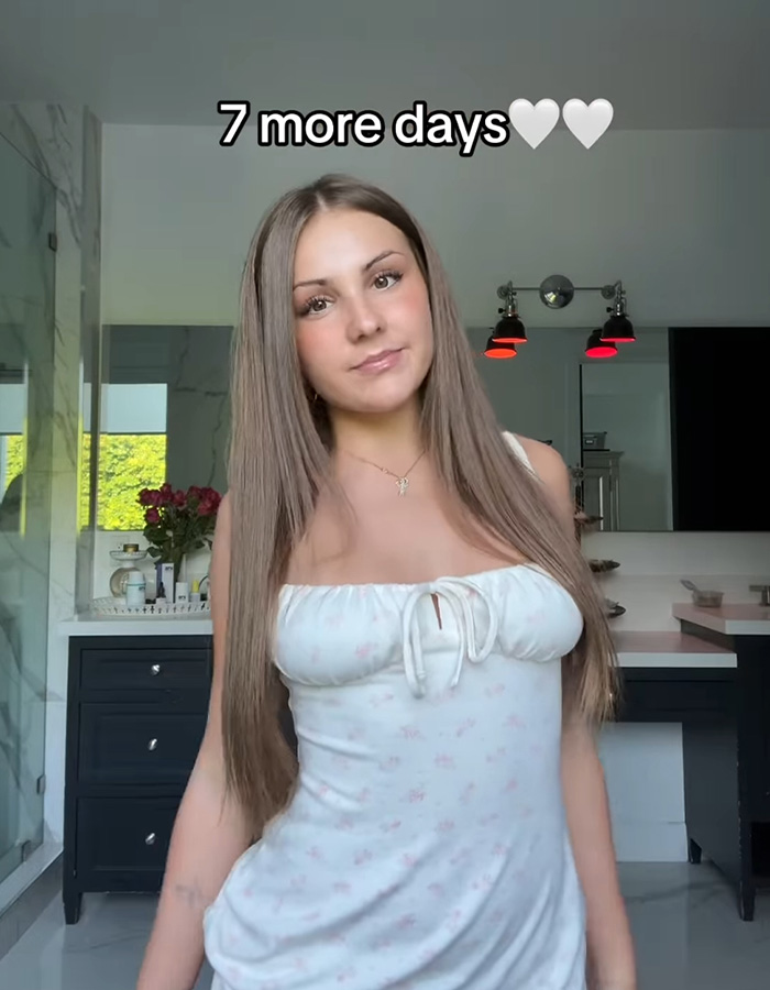 Teen influencer posing indoors with long hair and white dress, promoting app debut that nets $1M in first hour.