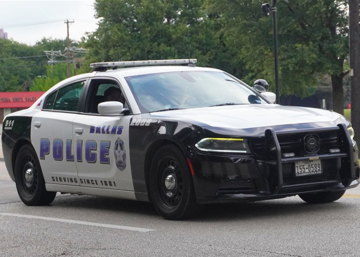Closure: Dallas police cruiser parked on street, black and white patrol car with POLICE markings Closure: Dallas police cruiser parked on street, black and white patrol car with POLICE markings