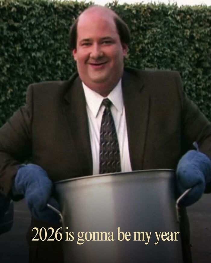 Character from The Office making a funny meme about 2026, wearing a suit and oven mitts with a large pot outdoors.