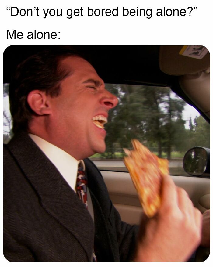 Man from The Office laughing loudly while eating pizza in a car, a popular meme inspired by the TV series.