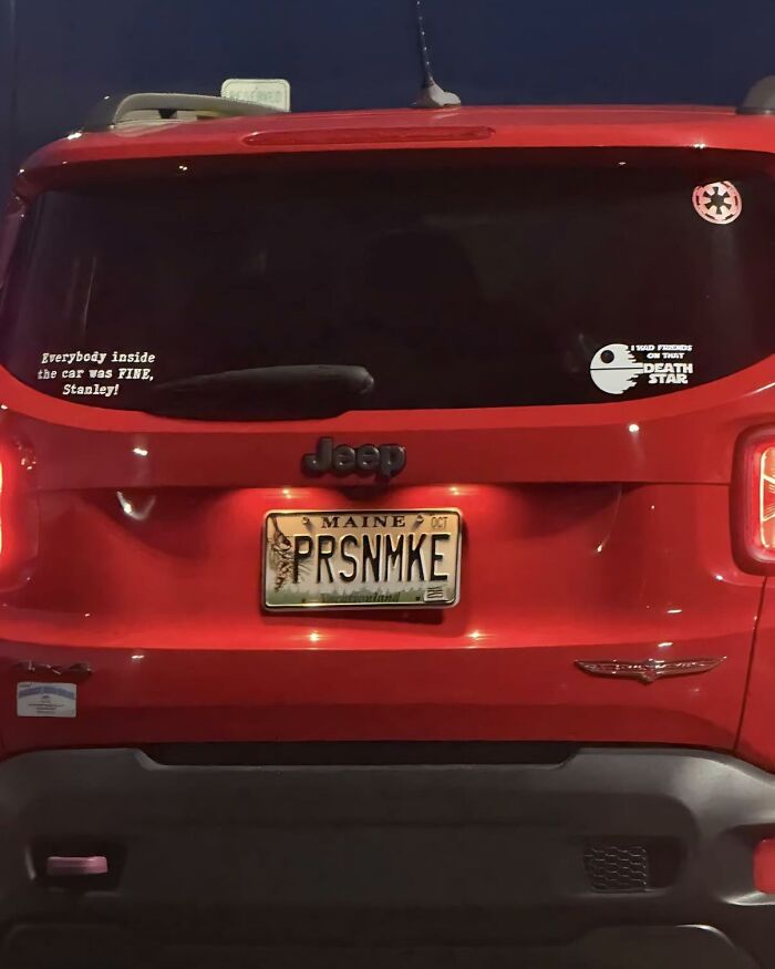 Red Jeep with The Office inspired stickers, including a Stanley quote and Death Star decal on the rear window.