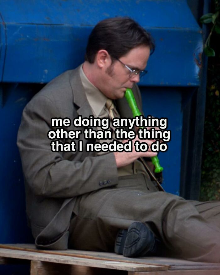 Man in suit sitting and playing recorder, a meme inspired by popular TV series The Office memes.