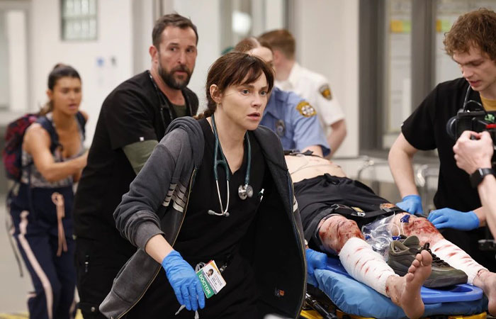 Medical team rushing a bleeding patient through hospital corridor in The Pitt season 2 episode 2 preview scene.