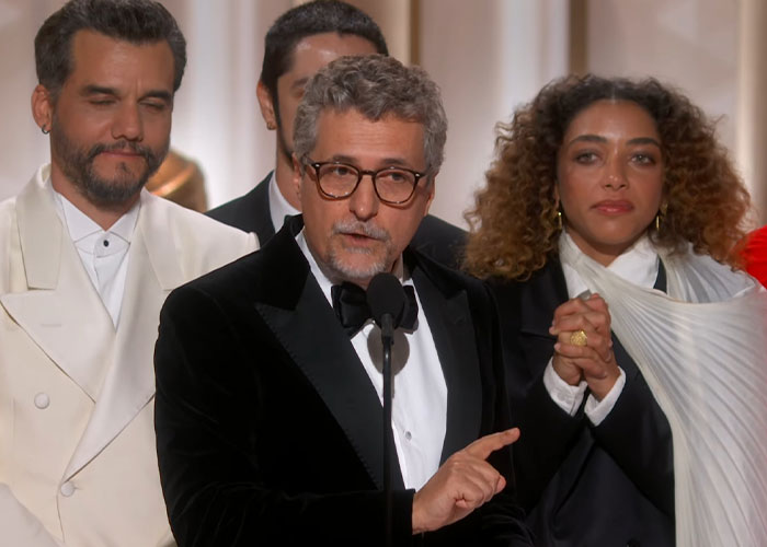 Four presenters on stage at the 2026 Golden Globes ceremony, captured during an awkward moment with serious expressions.