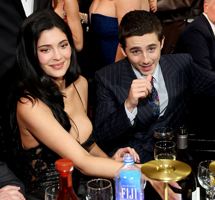 Timoth&eacute;e Chalamet at an event, dressed in a pinstripe suit, amid backlash over message for fans in Ukraine.