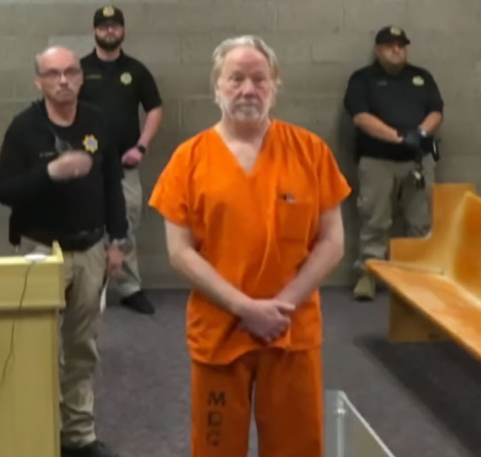 Timothy Busfield in orange prison jumpsuit standing in courtroom with officers, highlighting twist in Busfield case audio evidence.