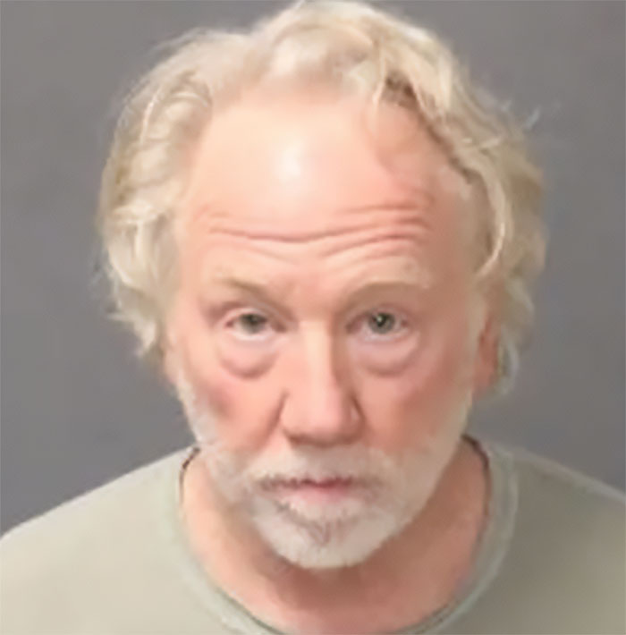 Close-up of a man with white hair and beard, appearing in a mugshot related to Melissa Gilbert and Timothy Busfield news.