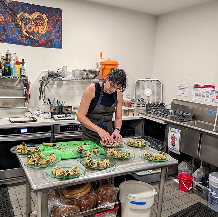 A chef preparing plated pastries in a commercial kitchen, related to coverage of trans chef controversy. A chef preparing plated pastries in a commercial kitchen, related to coverage of trans chef controversy.