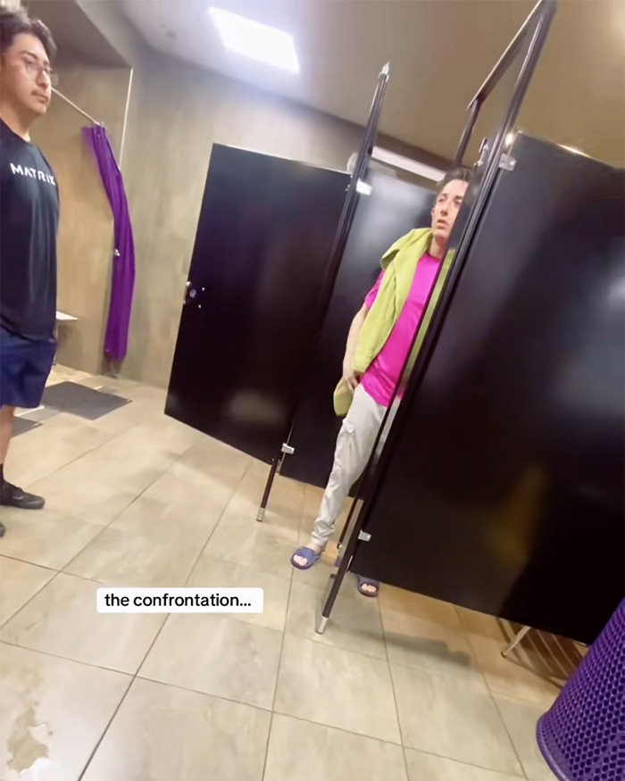 Two people in a locker room engaged in a tense confrontation related to Planet Fitness bathroom and locker room policies. Two people in a locker room engaged in a tense confrontation related to Planet Fitness bathroom and locker room policies.