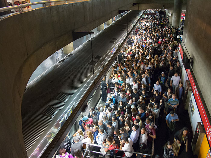 Crowded subway platform filled with people experiencing an unexplainable moment, capturing urban life and mystery.