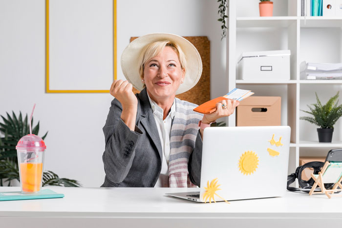 Woman at desk expressing relief and confidence, symbolizing a DIL putting her foot down against overbearing MIL plans.