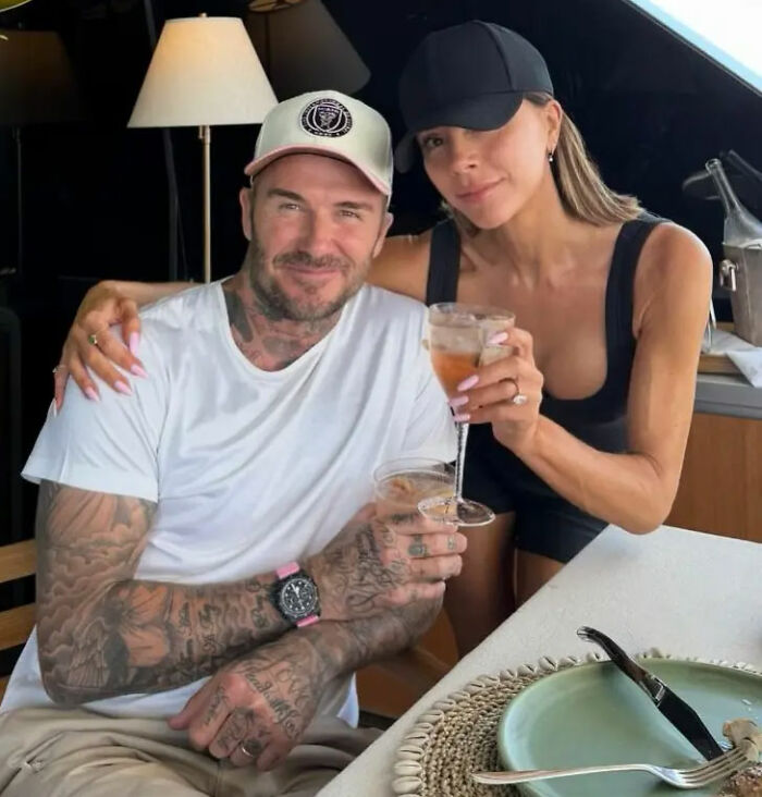 David and Victoria Beckham sitting together with drinks, amidst Brooklyn Beckham family feud and legal dispute headlines.
